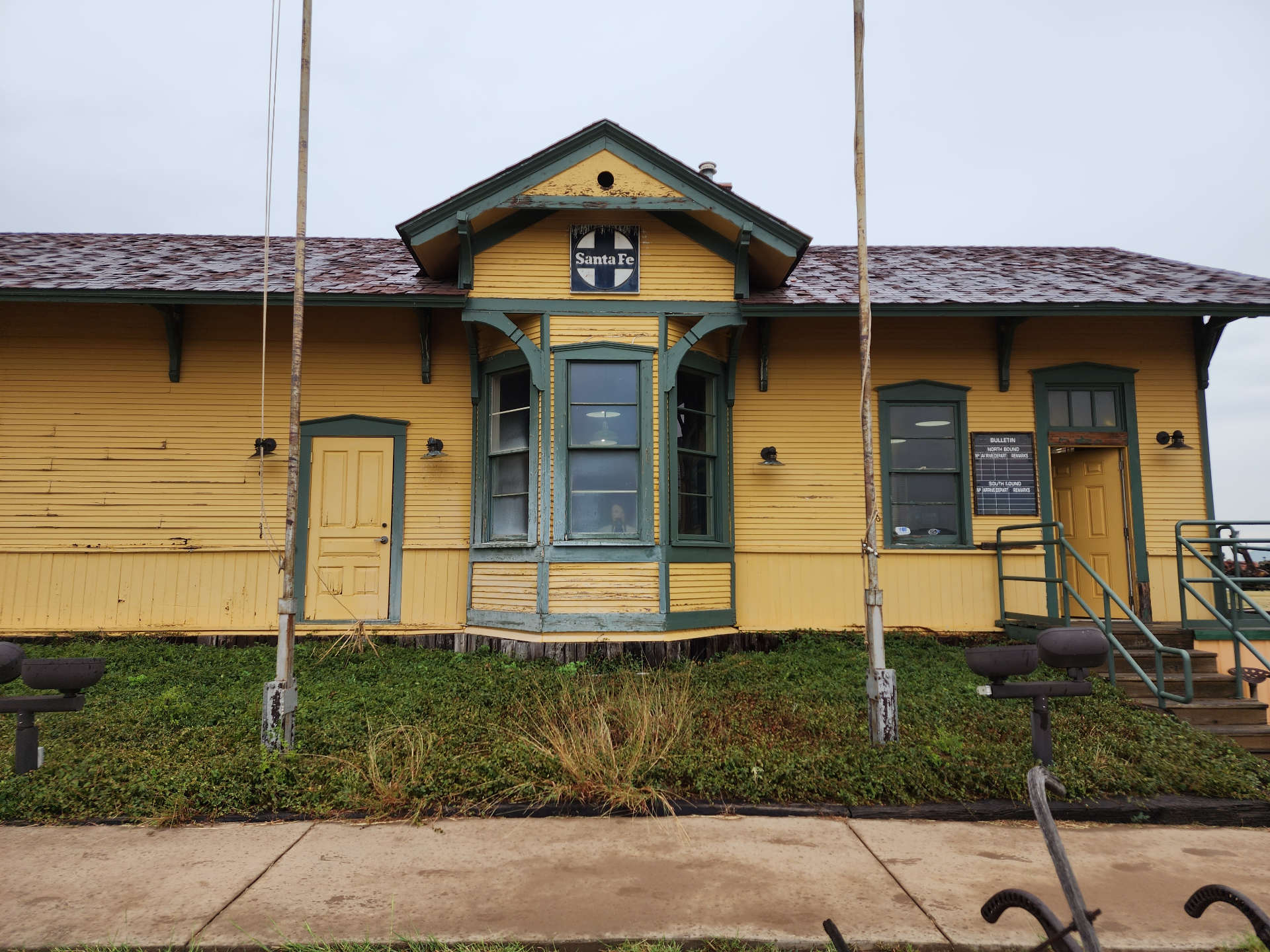 The historic yellow-and-green Santa Fe railroad depot building in Hale County, Texas